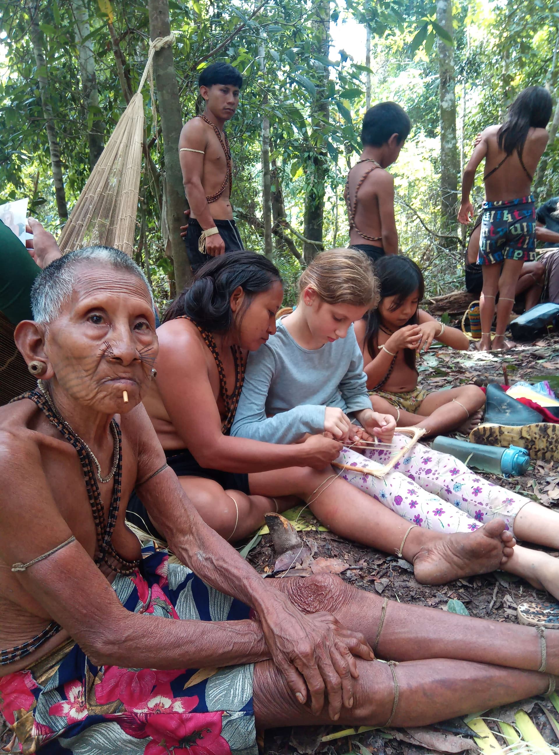 Traveler participating in an indigenous cultural exchange in the Amazon